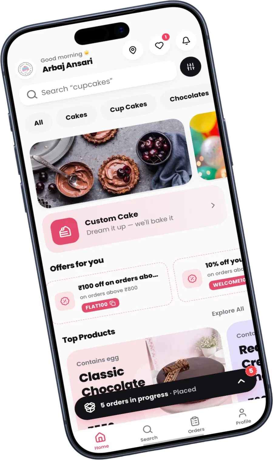 A bakery's own Frostique ordering app on a phone, showing its home screen with cakes, offers and order tracking